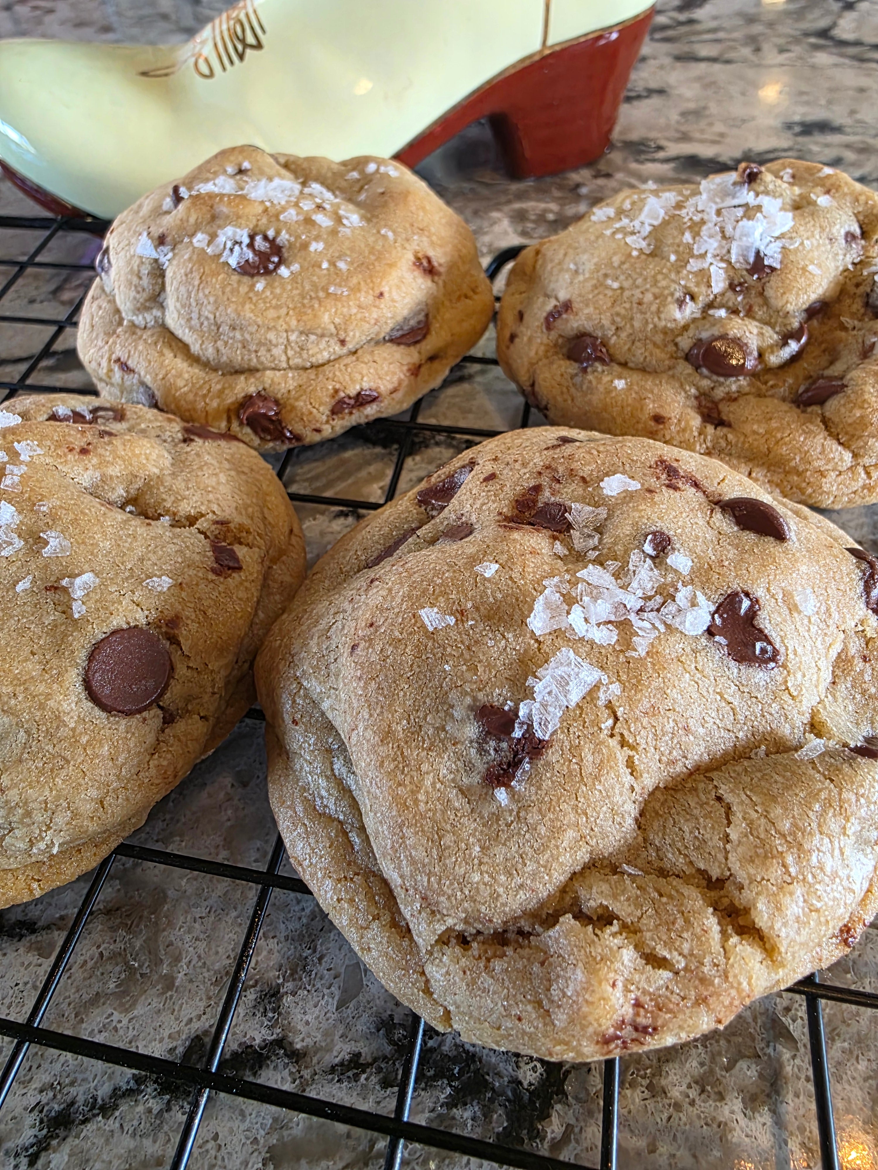 Chocolate chip cookies with sea salt on a cooling rack